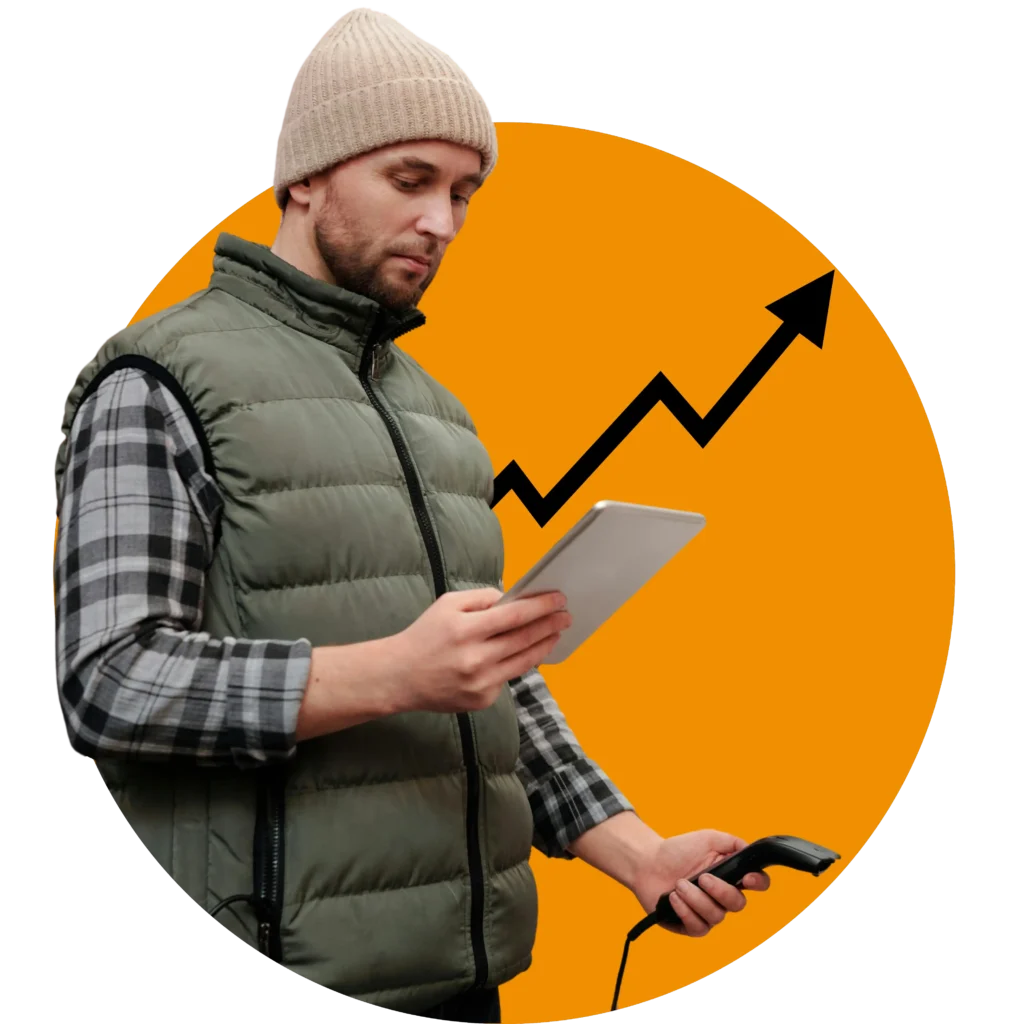 A man in a beanie and puffer gilet holds a tablet and a barcode scanner, standing in front of an orange background with a rising arrow graph.